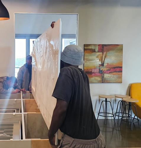 Trend Stone workers carrying a stone worktop for an installation on site