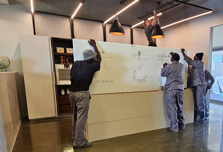 Trend Stone workers carrying a stone worktop for an installation on site